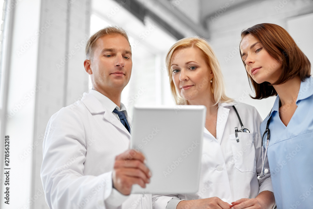 healthcare, medicine and technology concept - group of doctors with tablet computer at hospital healthcare, medicine and technology concept - group of doctors with tablet computer at hospital