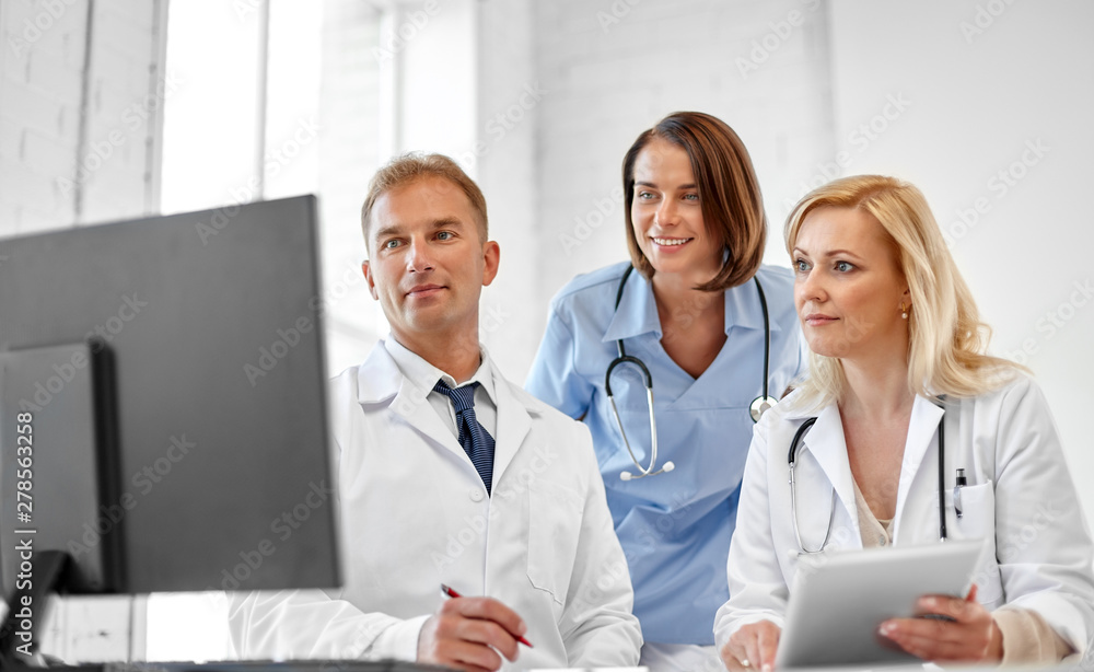 healthcare, medicine and technology concept - group of doctors with computer at hospital healthcare, medicine and technology concept - group of doctors with computer at hospital