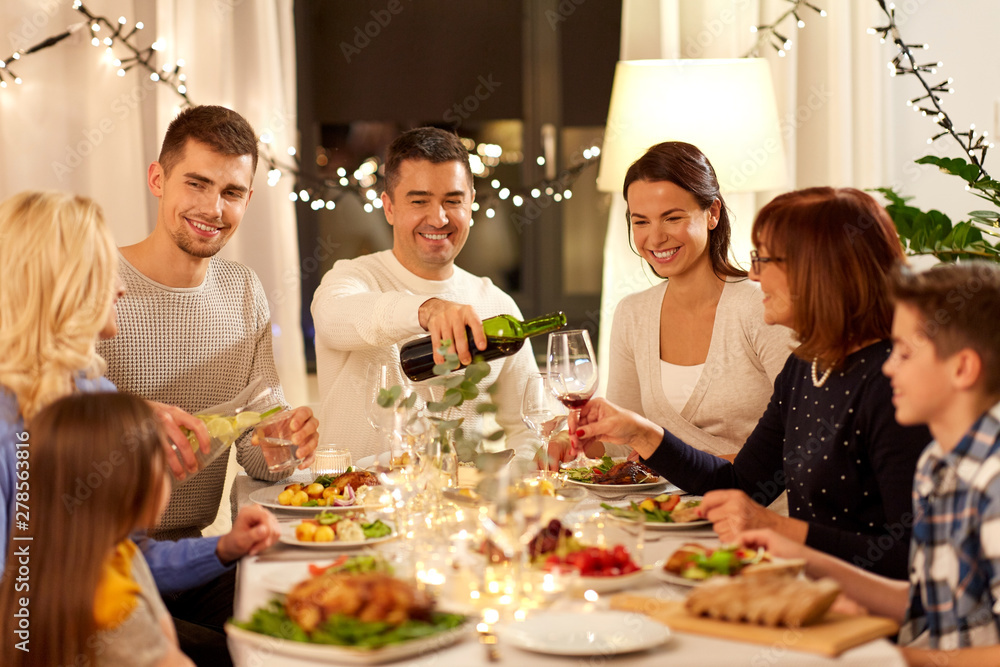 celebration, holidays and people concept - happy family having dinner party at home celebration, holidays and people concept - happy family having dinner party at home