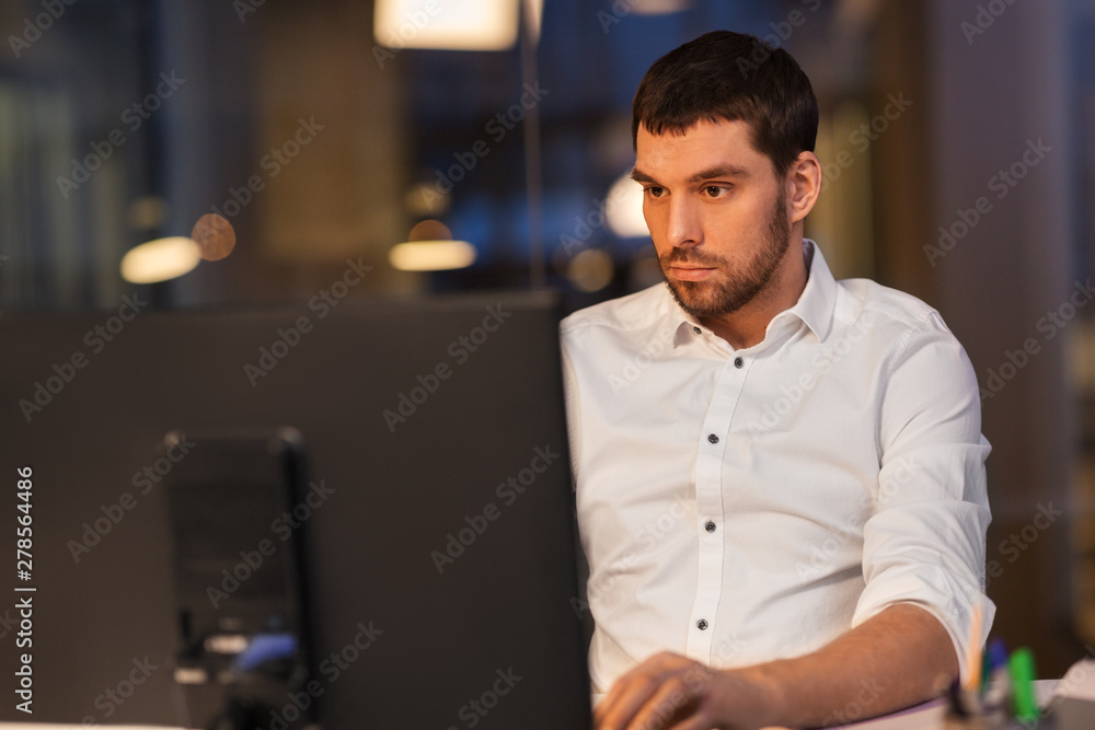 business, overwork, deadline and people concept - businessman with computer working at night office business, overwork, deadline and people concept - businessman with computer working at night office