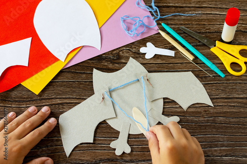 The child draws the details of dracola bat toy Halloween. Children's art project, craft for children. Craft for kids. photo