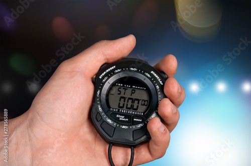 Human hand uses the speedometer on the background of blurred lights