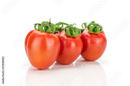 Group of three whole fresh red tomato cherry isolated on white background