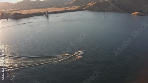 Aerial Drone Tracking Shot of a Boat with Two Waterskiers on.a Mountain Lake (Lake Kaweah, Visalia, California)