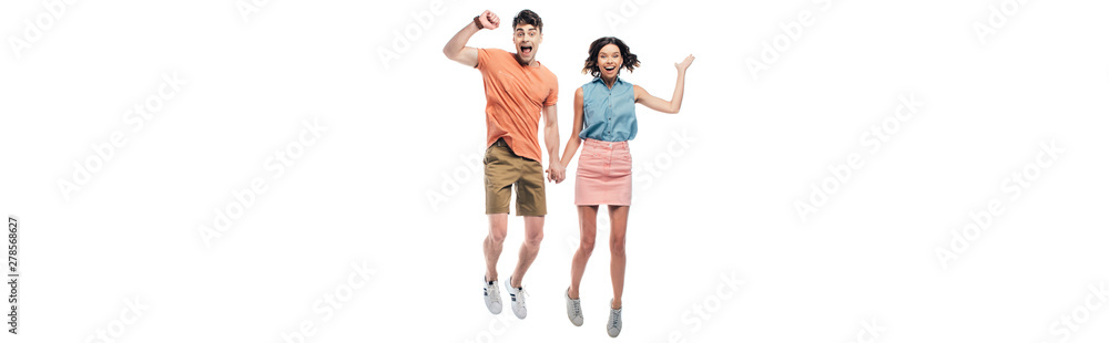 panoramic shot of happy man and woman holding hands and jumping while showing triumph gestures isolated on white panoramic shot of happy man and woman holding hands and jumping while showing triumph gestures isolated on white