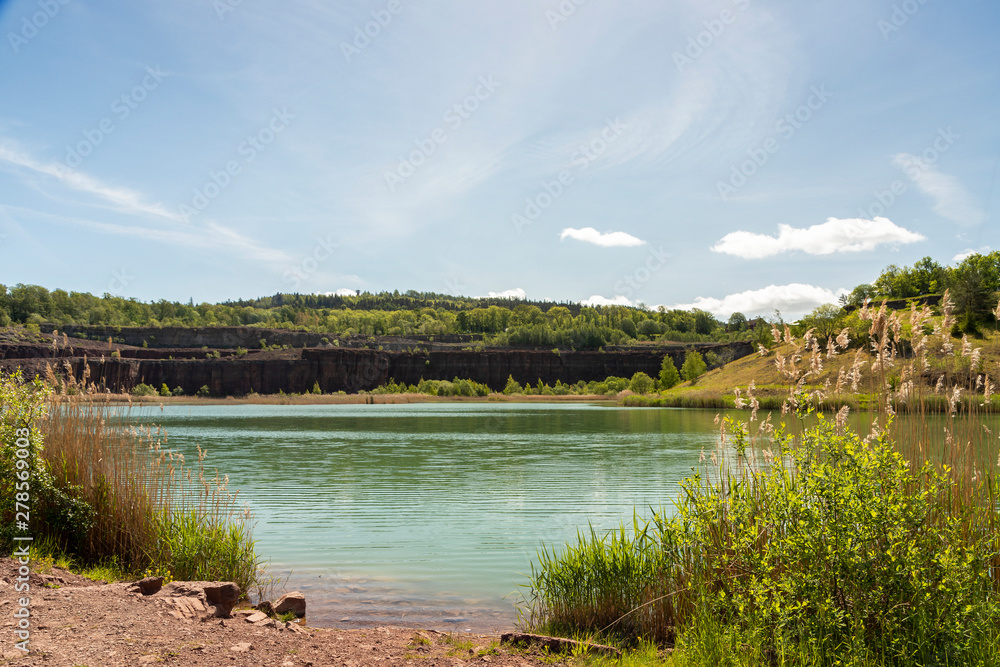 Scenic view of lake in an old quarry against sky