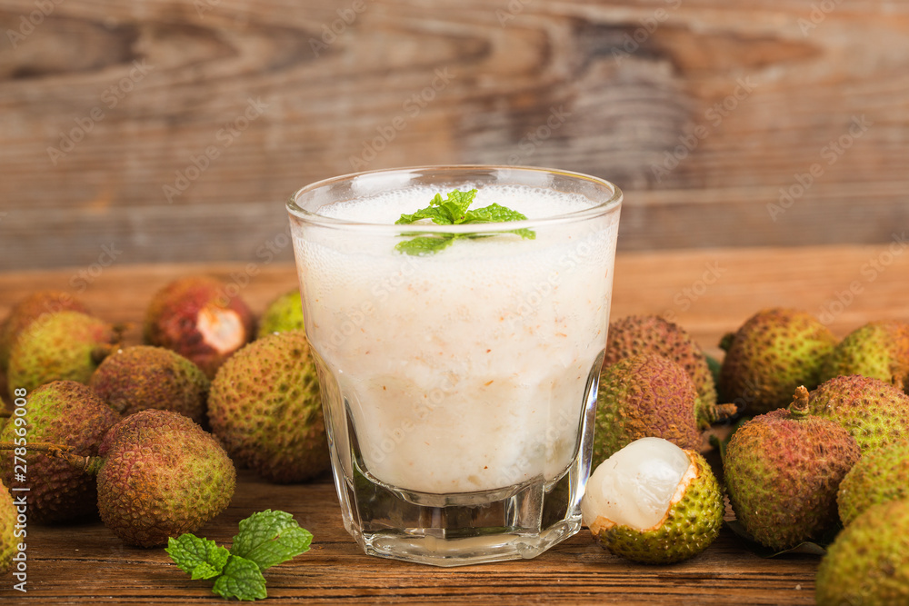 Fresh made Lychee Juice on wooden background