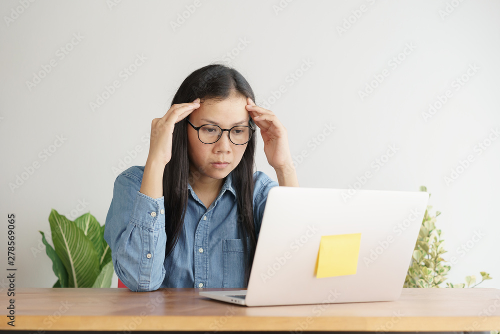 Asian women stressful working with a computer for a long time, Office syndrome concept Asian women stressful working with a computer for a long time, Office syndrome concept