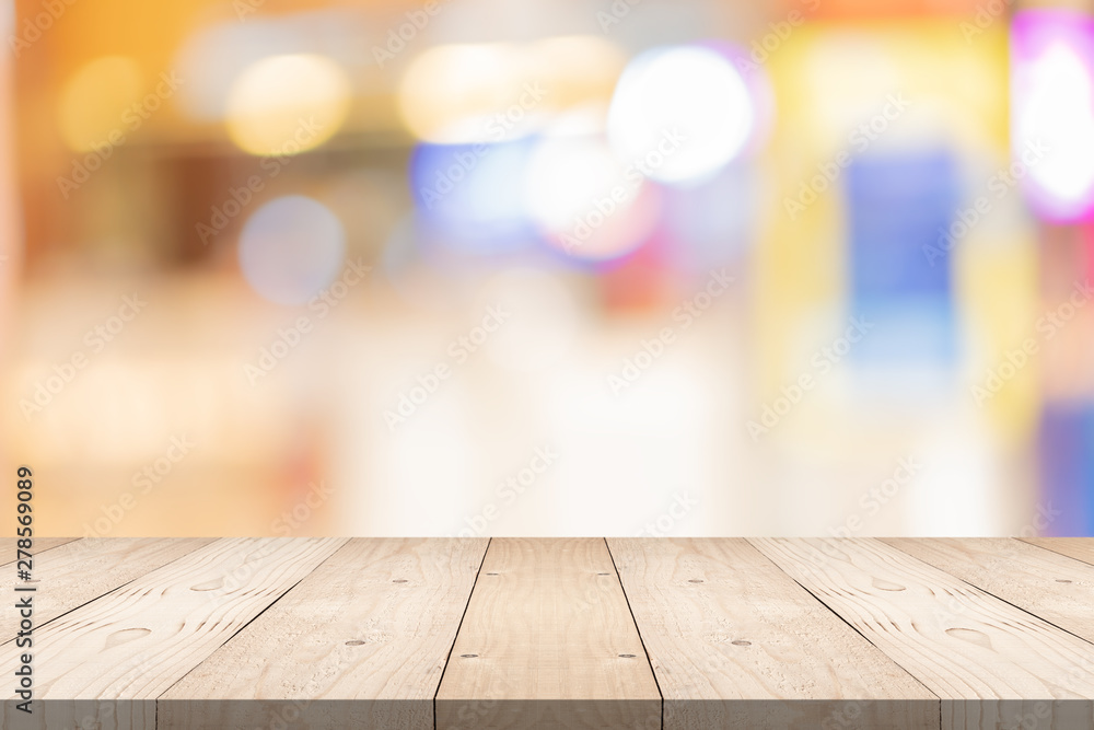 Empty brown wood table top on blur background at shopping mall, copy space for montage you product Empty brown wood table top on blur background at shopping mall, copy space for montage you product