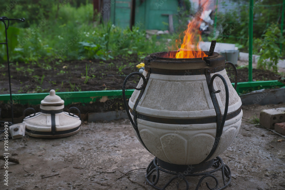 fire with charcoal in a compact home tandoor at the cottage fire with charcoal in a compact home tandoor at the cottage