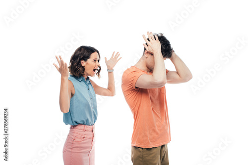 angry young woman gesturing while quarreling at offended boyfriend isolated on white