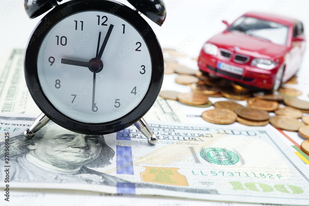 Alarm clock on US dollar banknotes for car loan : Banking Account, Investment Analytic research data economy, trading, Business company concept. Alarm clock on US dollar banknotes for car loan : Banking Account, Investment Analytic research data economy, trading, Business company concept.