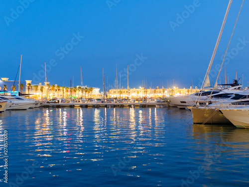 Beautiful harbor and promenade lit in the evening in Alicante. Spain.