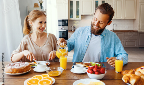 family happy couple have Breakfast in kitchen in morning