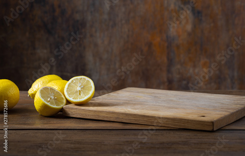 Tableau sur Toile Kitchen table with empty cutting board and lemon