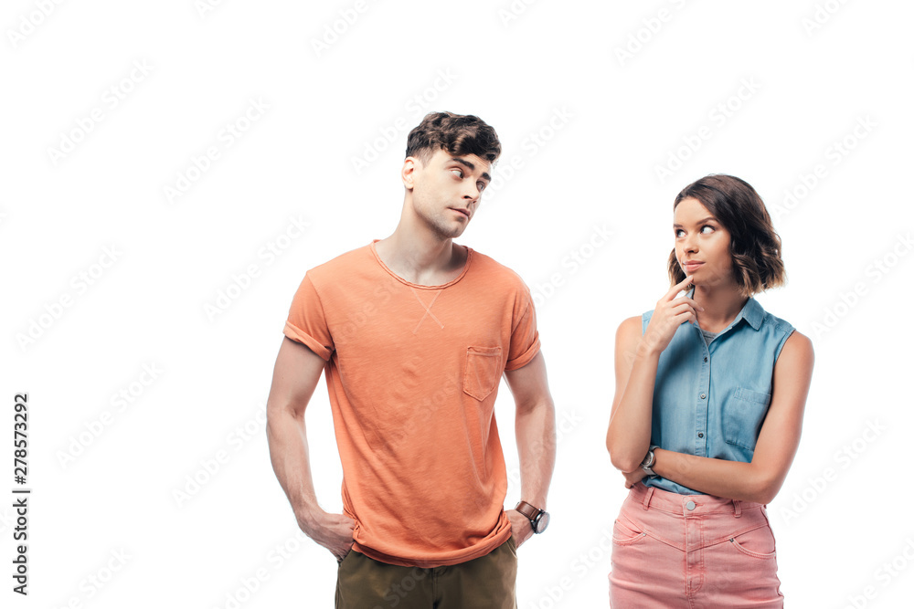 Fototapeta premium offended boyfriend looking at thoughtful girl isolated on white