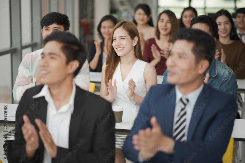 Young Asian people audiences seminar group smile and applaud to the speaker in meeting room. seminar and training concept. Young Asian people audiences seminar group smile and applaud to the speaker in meeting room. seminar and training concept.