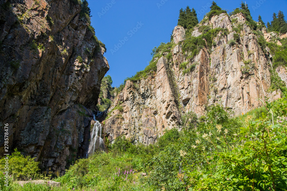 Butakovsky waterfall in the mountains of the city of Almaty, Kazakhstan. Summer in the mountains Butakovsky waterfall in the mountains of the city of Almaty, Kazakhstan. Summer in the mountains