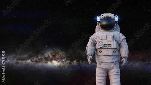 astronaut standing in front of the Milky Way galaxy