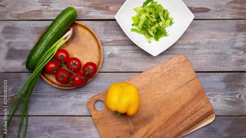 Fresh vegetables. Someone cutting vegetables on the cutting board and making salad. Then eats it. Stop motion animation. 4k Fresh vegetables. Someone cutting vegetables on the cutting board and making salad. Then eats it. Stop motion animation. 4k