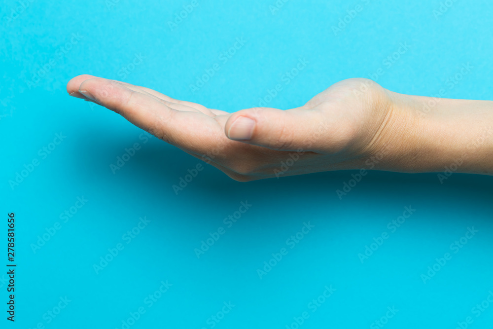 Person holding something on a blue background