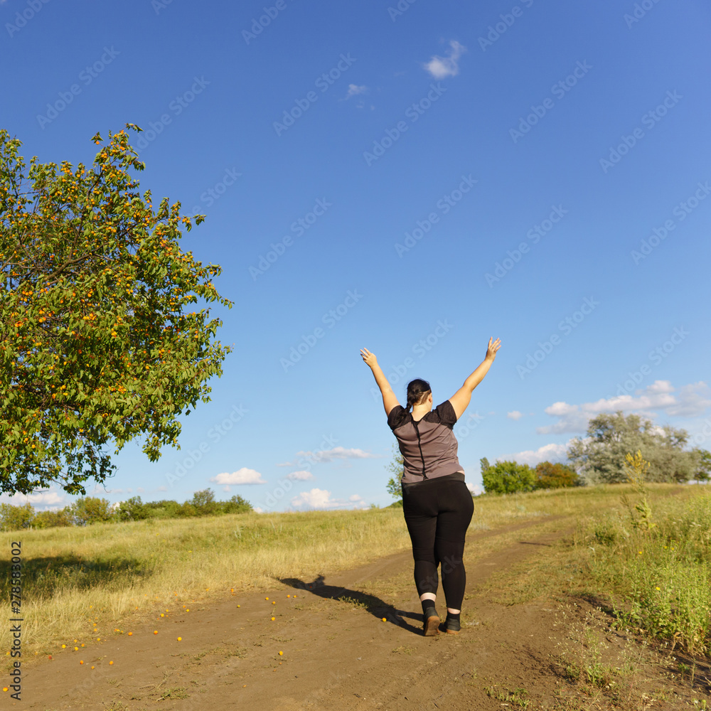Happy woman standing in nature with open hands. Self esteem, body positive, life goals concept Happy woman standing in nature with open hands. Self esteem, body positive, life goals concept