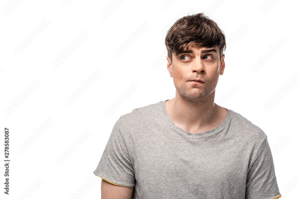 discouraged young man in grey t-shirt looking away isolated on white discouraged young man in grey t-shirt looking away isolated on white