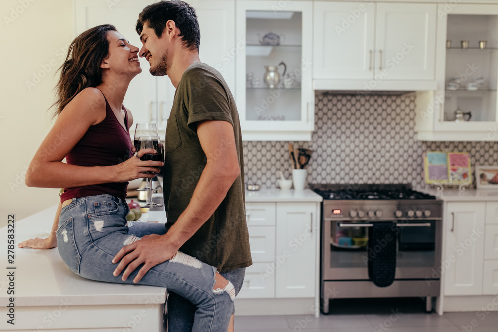 Couple romancing in kitchen Couple romancing in kitchen