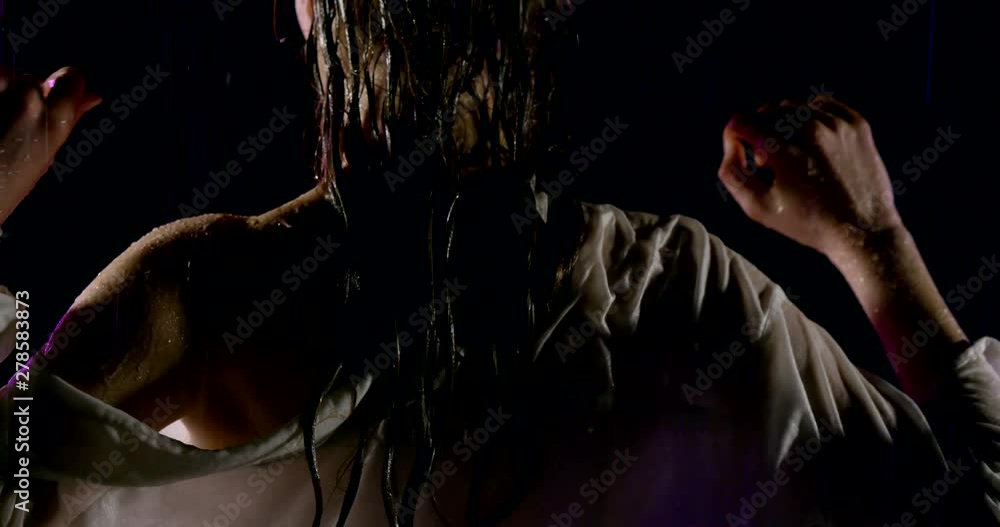 sexy wet woman is moving under water flows, back view, one naked shoulder and long dark hair sexy wet woman is moving under water flows, back view, one naked shoulder and long dark hair