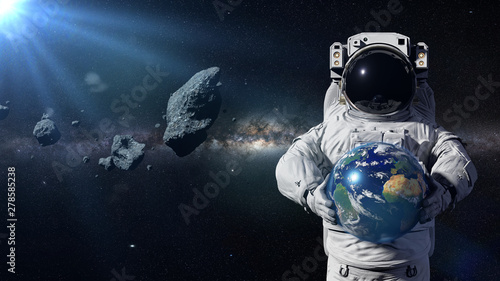 Fototapeta Naklejka Na Ścianę i Meble -  astronaut protecting planet Earth from asteroids