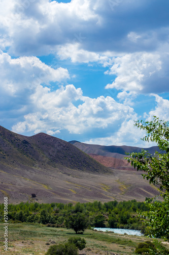 Steppe landscapes of Kazakhstan. Sky with clouds over the mountains