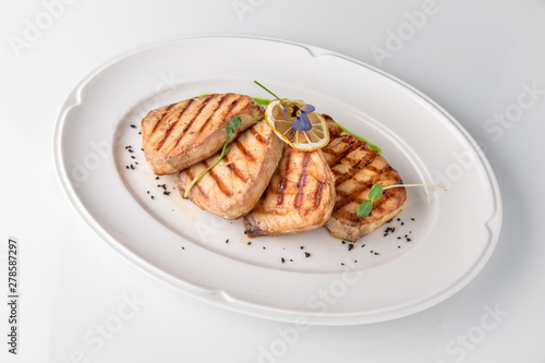 Grilled salmon fish fillet (red fish). Seafood. Banquet festive dishes. Fine dining restaurant menu. White background.