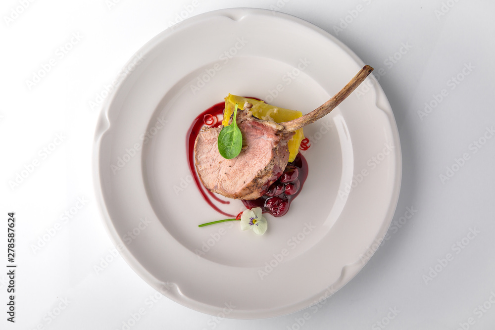 Calf or pork ribs cooked in the oven with cherry sauce, vegetable puree. Beef or pork meat. Banquet festive dishes. Fine dining restaurant menu. White background. Calf or pork ribs cooked in the oven with cherry sauce, vegetable puree. Beef or pork meat. Banquet festive dishes. Fine dining restaurant menu. White background.
