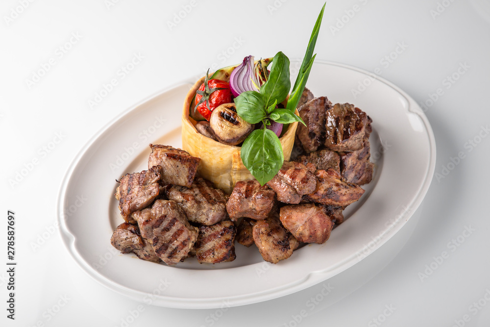 Skewers of pork, beef with vegetables and mushrooms. Grilled meat. Banquet festive dishes. Fine dining restaurant menu. White background. Skewers of pork, beef with vegetables and mushrooms. Grilled meat. Banquet festive dishes. Fine dining restaurant menu. White background.