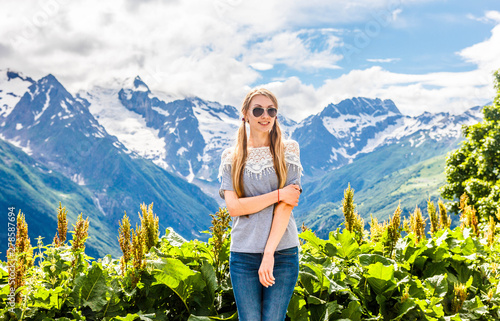 Blonde girl with long hair on vacation in the resort of Dombai in the summer, summer vacation in the mountain resort of the Caucasus © Igor Luschay