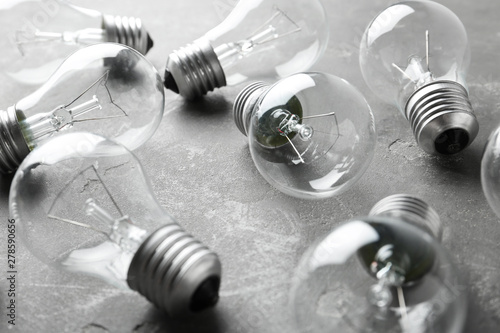 Εκτύπωση καμβά New incandescent lamp bulbs on grey stone surface