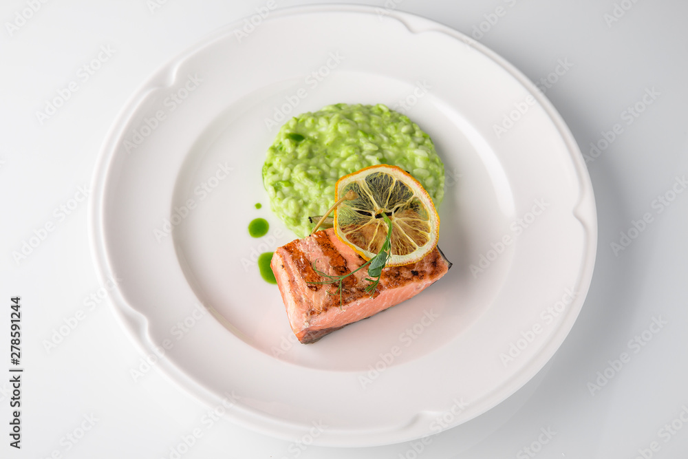 Grilled fish fillet salmon. Selected pieces of red fish. Seafood. Banquet festive dishes. Fine dining restaurant menu. White background. Grilled fish fillet salmon. Selected pieces of red fish. Seafood. Banquet festive dishes. Fine dining restaurant menu. White background.