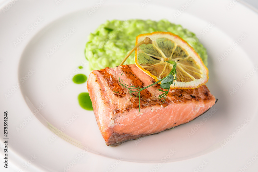 Grilled fish fillet salmon. Selected pieces of red fish. Seafood. Banquet festive dishes. Fine dining restaurant menu. White background. Grilled fish fillet salmon. Selected pieces of red fish. Seafood. Banquet festive dishes. Fine dining restaurant menu. White background.