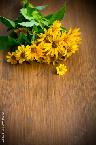 bouquet of yellow big daisies on a wooden
