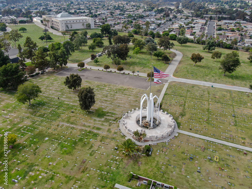 Aerial view of Greenwood Memorial Park & Mortuary. Memorial statue with American flag. Funeral, cemetery in San Diego, California, USA.  photo