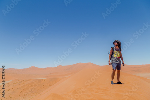 Homme debout dans le désert sur une dune de sable