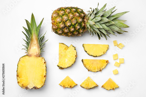 Flat lay composition with cut and fresh juicy pineapples on white background