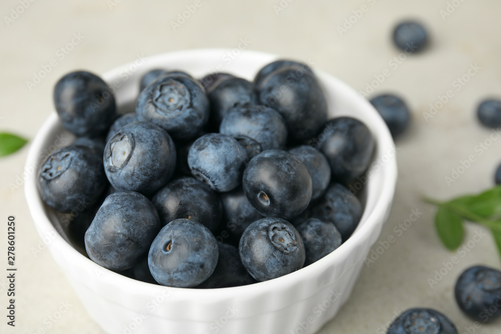 Bowl with tasty blueberries on light table, closeup Bowl with tasty blueberries on light table, closeup