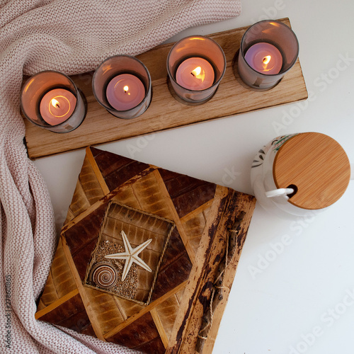 candles. a cup. the cloth. photo album on the table