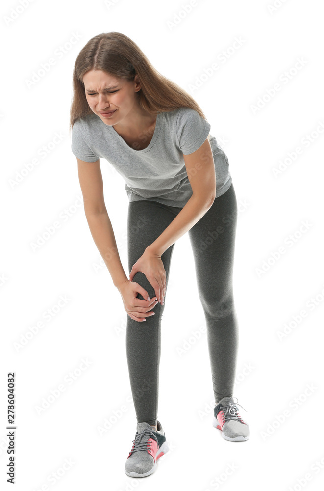 Full length portrait of sportswoman having knee problems on white background Full length portrait of sportswoman having knee problems on white background