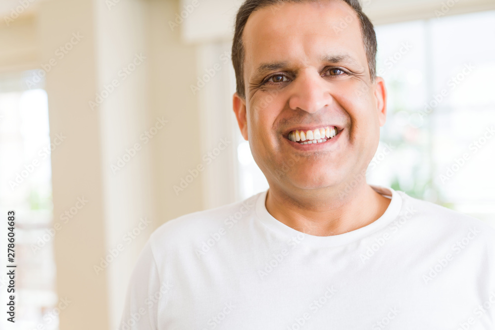 Middle age man smiling confident to the camera at home Middle age man smiling confident to the camera at home