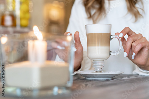 coffee latte on table with candles. Romantic mood.