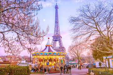 The Eiffel Tower and vintage carousel on a winter evening in Paris, France.