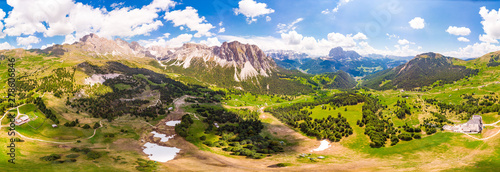 Aerial top view from drone to Col Raiser plateau In sunny summer Day. Scenery of rugged Sella Mountain with green valley on grassy hillside village St. Cristina di Val Gardena, Bolzano, Seceda Italy.