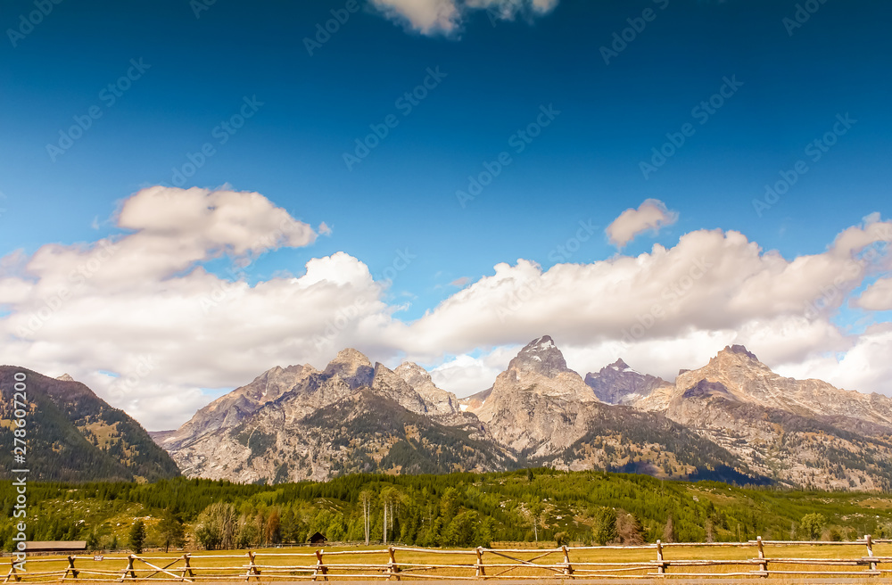 Looking at Tetons across fencing of ranch east of Grand Teton National Park